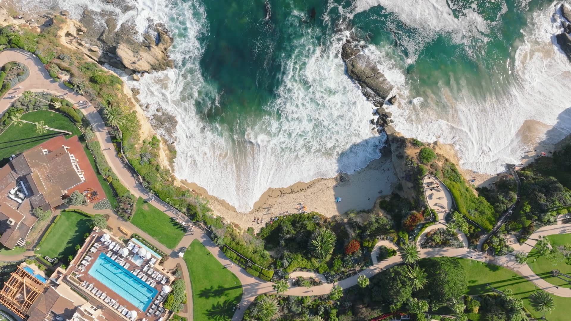 Aerial view of the Laguna Beach coastline at sunrise, with coves, headlands, and the Pacific Ocean