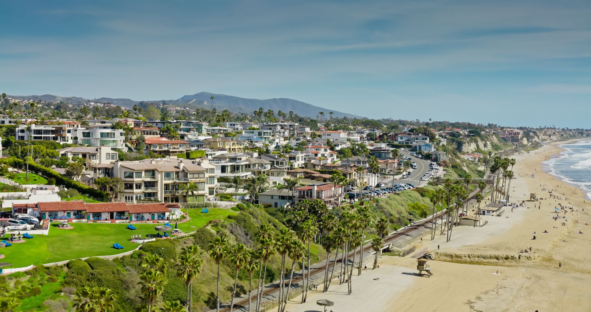Aerial view of San Clemente's coastal bluffs, beachfront homes, and the Pacific Ocean